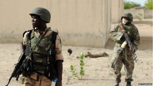 Nigerian soldiers patrol in the north of Borno state close to a Islamist extremist group Boko Haram former camp on 5 June 2013