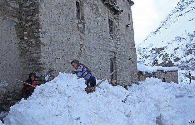 Afghan children looks on in a village close to an avalanche site in Panjshir province north of Kabul, Afghanistan, Wednesday, Feb 25