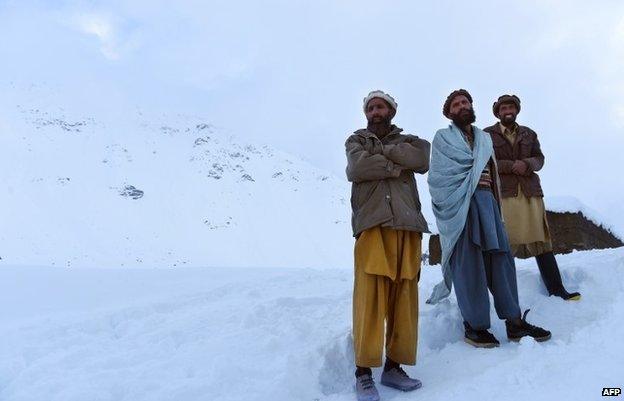 Relatives walk down from the site after searching for avalanche victims in the district of Bazarak in the province of Panjshir, north of Kabul on February 25