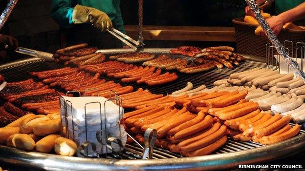 Market staff prepare Bratwurst