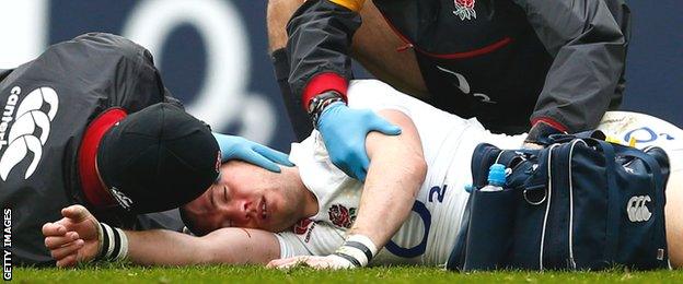 England full-back Mike Brown receives treatment by medics after being knocked out against Italy