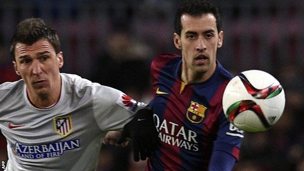 Barcelona midfielder Sergio Busquets (right)