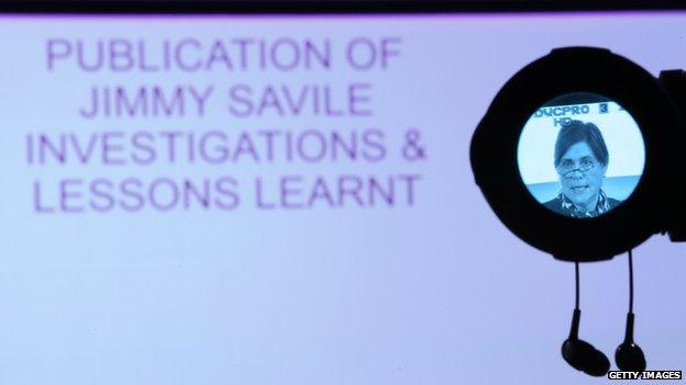 screen saying: "Jimmy Savile investigations & lessons learnt" plus Kate Lampard in camera viewfinder