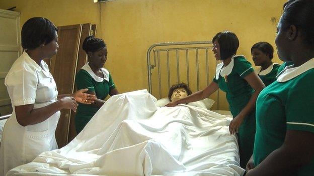 Trainee nurses in Ghana with a dummy patient in bed