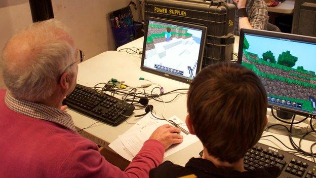 Older man and child at coding event