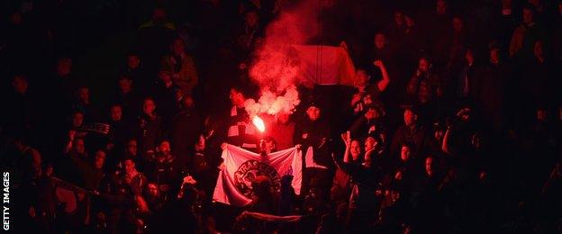 Celtic fans let off a flare