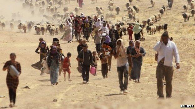 Displaced people from the minority Yazidi sect, fleeing violence from forces loyal to the Islamic State in Sinjar town