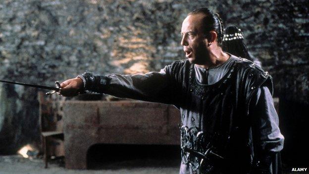 Scene from Macbeth showing title character clutching dagger