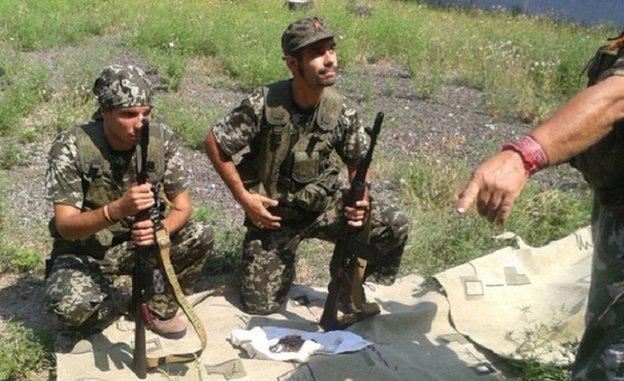 Picture published on Spanish Interior Ministry website apparently showing Spanish nationals fighting with weapons in Ukraine