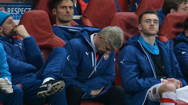 Arsenal's manager Arsene Wenger (front) watches his side in action against Monaco