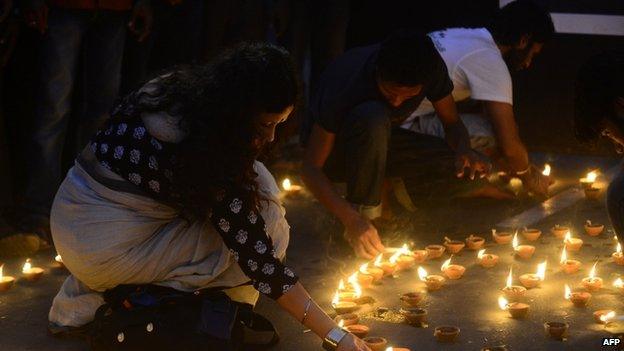 Bangladeshi secular activists light candles during a protest against the killing of Mr Roy