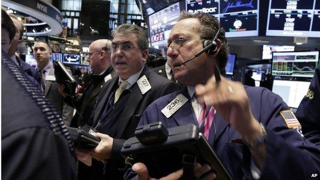 Traders work on the floor of the New York Stock Exchange