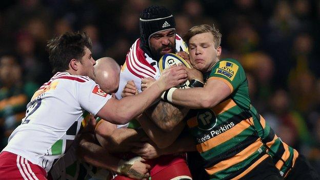 Northampton and Harlequins players battle for the ball