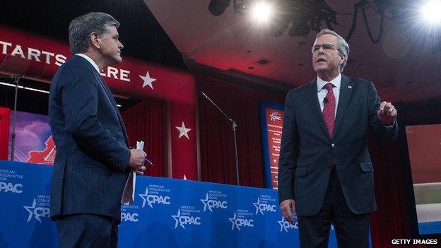 Fox News host Sean Hannity and Jeb Bush take the stage at CPAC.