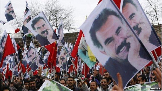 Kurdish protesters in Istanbul wave banners showing Abdullah Ocalan, Feb 2015