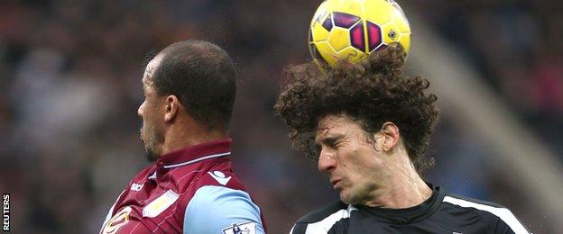 Fabricio Coloccini wins a header against Gabriel Agbonlahor