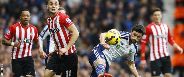 Claudio Yacob makes a tackle in midfield