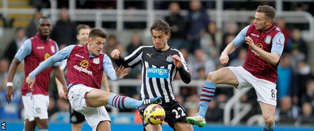 Aston Villa's Ashley Westwood (left) and Aston Villa's Tom Cleverley challenge Newcastle United's Daryl Janmaat