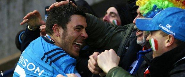 Italy scrum-half Edoardo Gori celebrates with fans