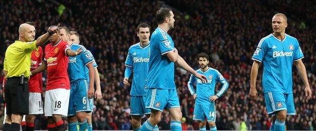 A bemused Sunderland defender Wes Brown (right) goes off after being red-carded at Manchester United