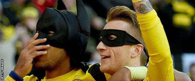 Borussia Dortmund players Pierre-Emerick Aubameyang and Marco Reus celebrate their team's first goal against Schalke