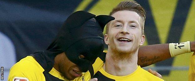 Borussia Dortmund players Pierre-Emerick Aubameyang and Marco Reus celebrate their team's first goal against Schalke