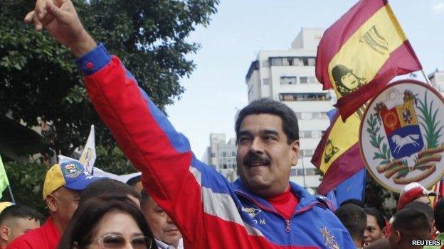 Venezuela"s President Nicolas Maduro (R) greets supporters during a rally to commemorate the 26th anniversary of the social uprising known as "Caracazo", which Venezuela"s late President Hugo Chavez said marked the start of his revolution, in this Caracas