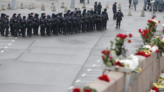 Police assemble near the scene of the shooting