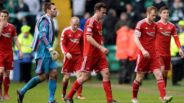 The Aberdeen players were left dejected after crashing to a 4-0 defeat t Celtic Park on Sunday