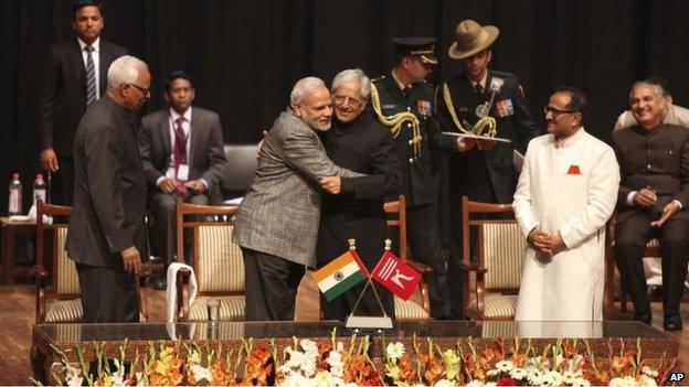 PM Narendra Modi, centre left, greets Peoples Democratic Party Mufti Mohammed Sayeed after the later was sworn in as the chief minister of Jammu and Kashmir state on Sunday, March 1, 2015.