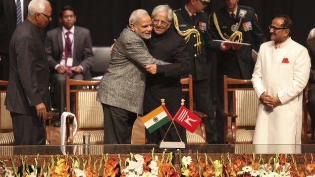 Indian PM Narendra Modi greets Mufti Mohammed Sayeed after the later was sworn in as the chief minister of Jammu and Kashmir on March 1, 2015