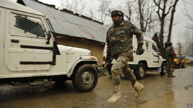 An Indian army soldier runs to get an ambulance after a colleague is injured during clashes with suspected rebels in Kashmir on Feb 25, 2015