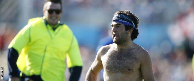 A streaker invades the pitch during England's game with Scotland