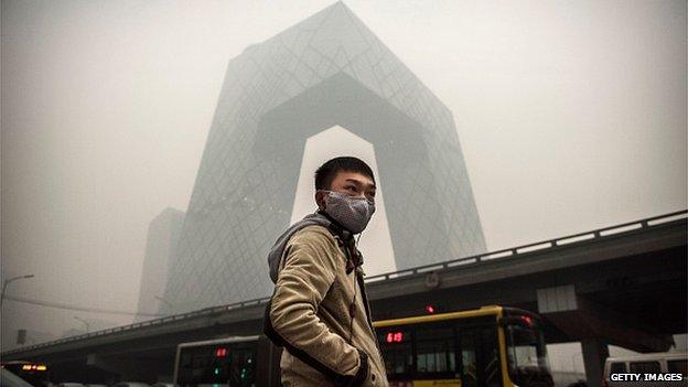 A man in front of CCTV offices in Beijing, China