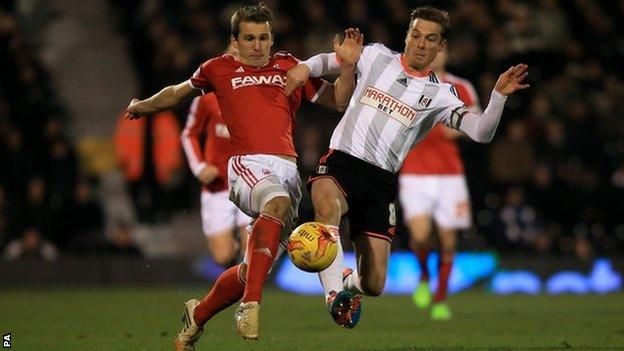 Robert Tesche tussles with Fulham's former England midfielder Scott Parker