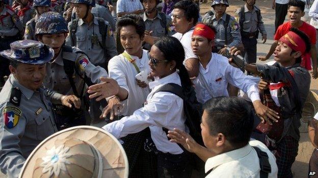 Student protesters confront police officers at a barricade that try to prevent them from joining another group of students in a monastery, in Letpadan, north of Yangon, Myanmar, Monday, 2 March 2015