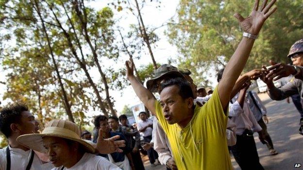 Student protesters and their supporters prevent vehicle movements, confronting police officers that stopped them from travelling on the same road to join another group of students in a monastery, in Letpadan, north of Yangon, Myanmar, Monday, 2 March 2015.