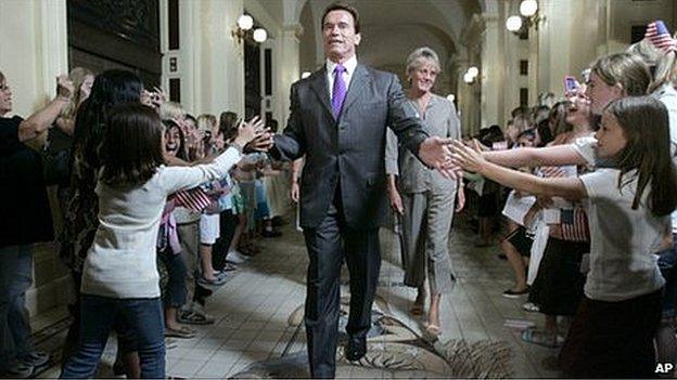 Arnold Schwarzenegger slapping the hands of school children