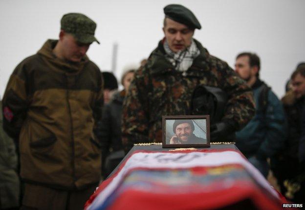 Mourners at the funeral in St Petersburg, Russia, of a Russian teacher killed in Donetsk fighting for the Ukrainian rebels