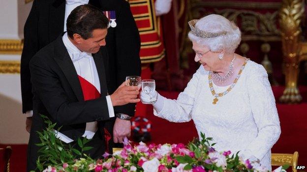 Mexican President Enrique Pena Nieto raises his glass in a toast with the Queen