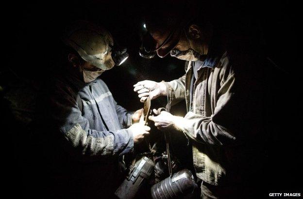 Coal miners work below the surface of the earth at Scheglovka Glubokaya mine in Makiivka, eastern Ukraine, 3 March