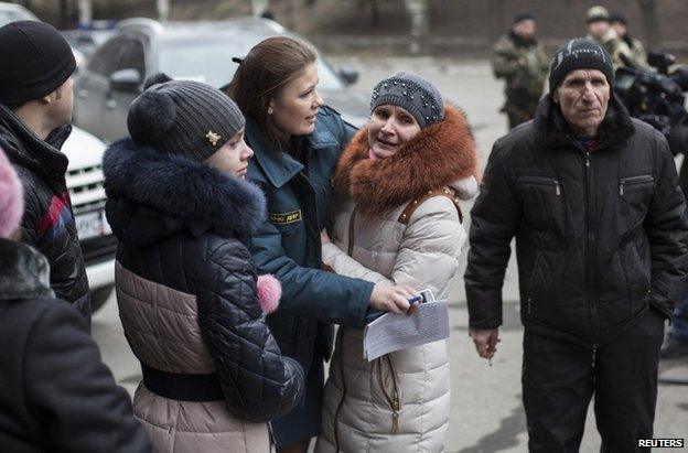 Family members stand outside the Zasyadko mine, 4 March