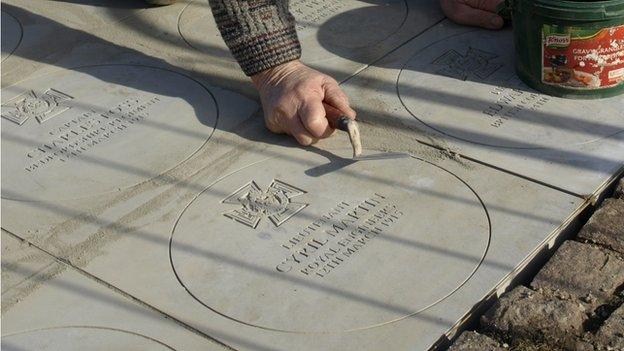 Laying the memorial slabs