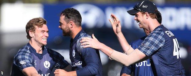 Preston Mommsen (centre) celebrates a catch against Afghanistan