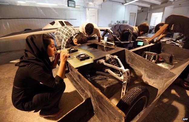 Woman student and solar-powered car