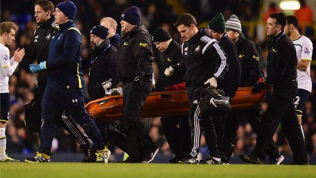 Bafetimbi Gomis on a stretcher