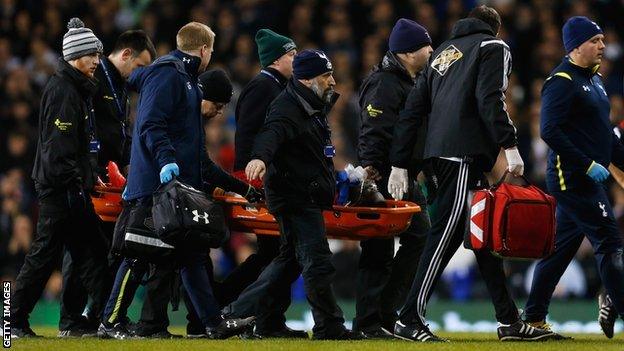 Swansea striker Bafetimbi Gomis was conscious and speaking as he was carried off at White Hart Lane