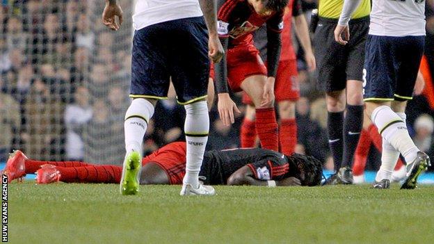 Swansea striker Bafetimbi Gomis was conscious and speaking as he was carried off at White Hart Lane