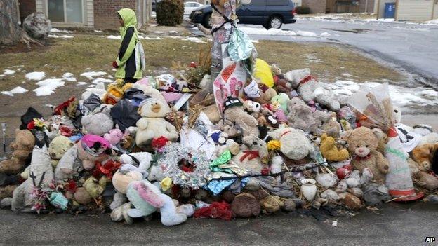 A boy walks past a memorial for Michael Brown, who was shot and killed by Ferguson, Missouri