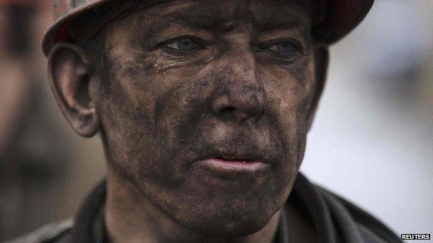 A miner waits for a bus after leaving the Zasyadko mine. Photo: 4 March 2015